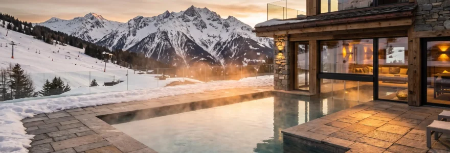 Outdoor heated pool at luxury Courchevel chalet with steam rising from water surface and snow-covered Alpine peaks visible in background under winter afternoon light
